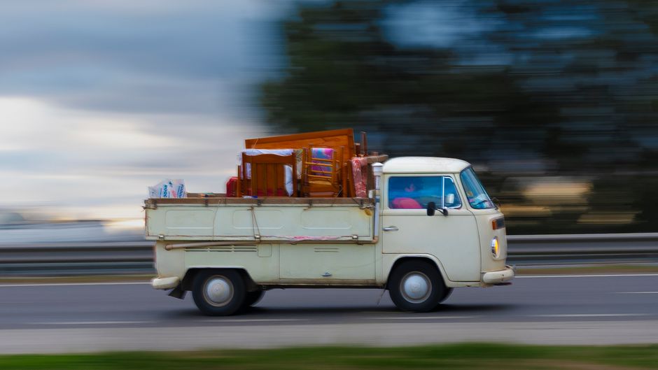 Removal van loaded with furniture and boxes during a house clearance