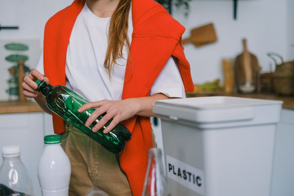 Person sorting household recyclable packaging at home before a tip visit