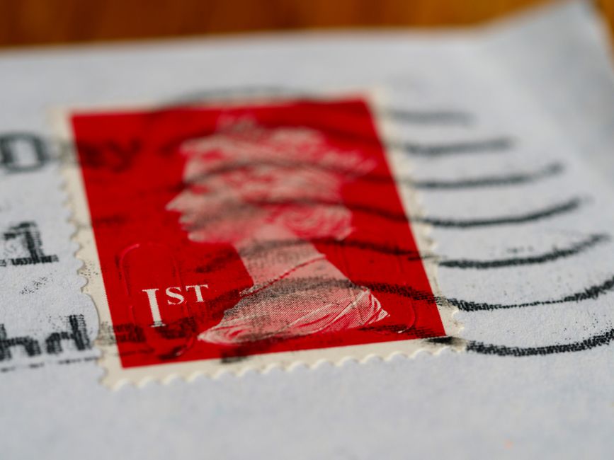 Close-up of a UK first class postage stamp on an envelope