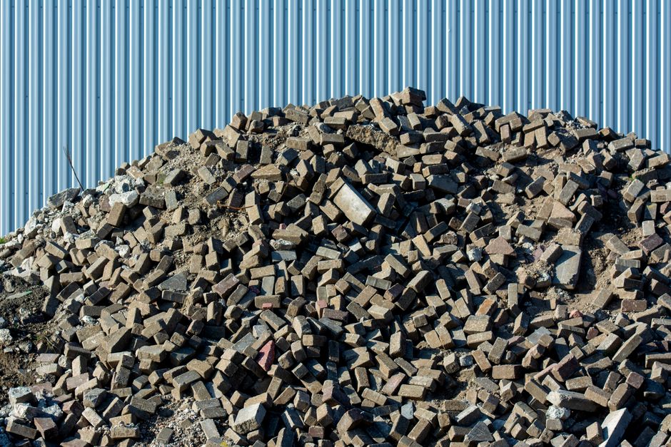A large pile of loose reclaimed bricks, the kind of material a grab lorry can scoop