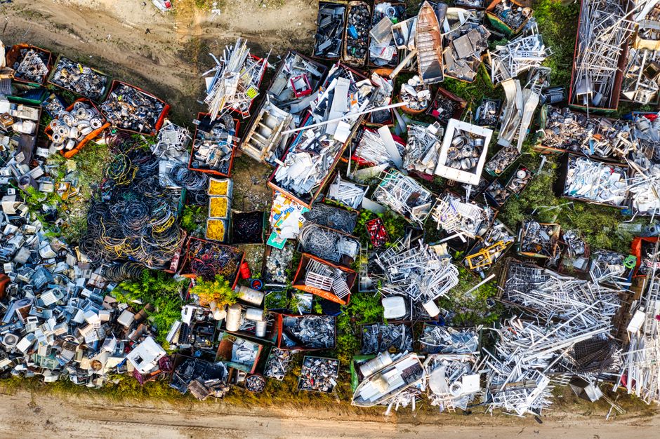Aerial view of sorted household waste and scrap materials in bays at a recycling yard