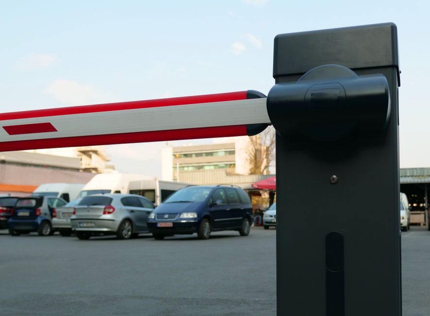 A car park entrance barrier controlling vehicle access at a site