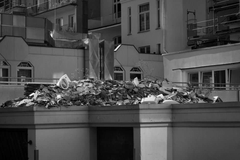 Demolition rubble and debris piled on a rooftop between buildings