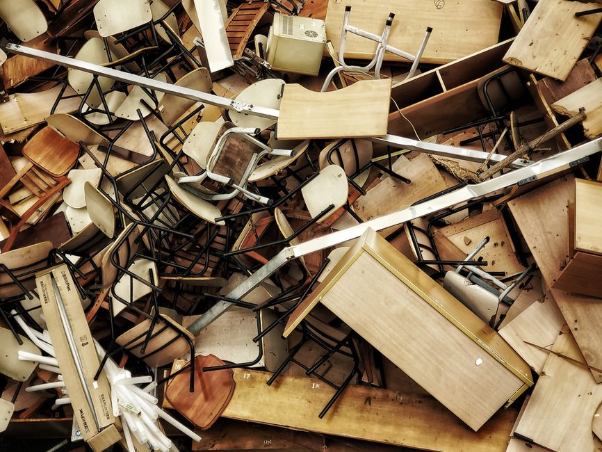 Pile of broken chairs, tables and old furniture collected for junk removal