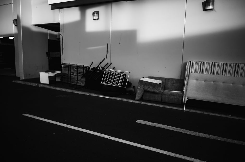 Old sofa and furniture left out for bulky waste collection on a residential street